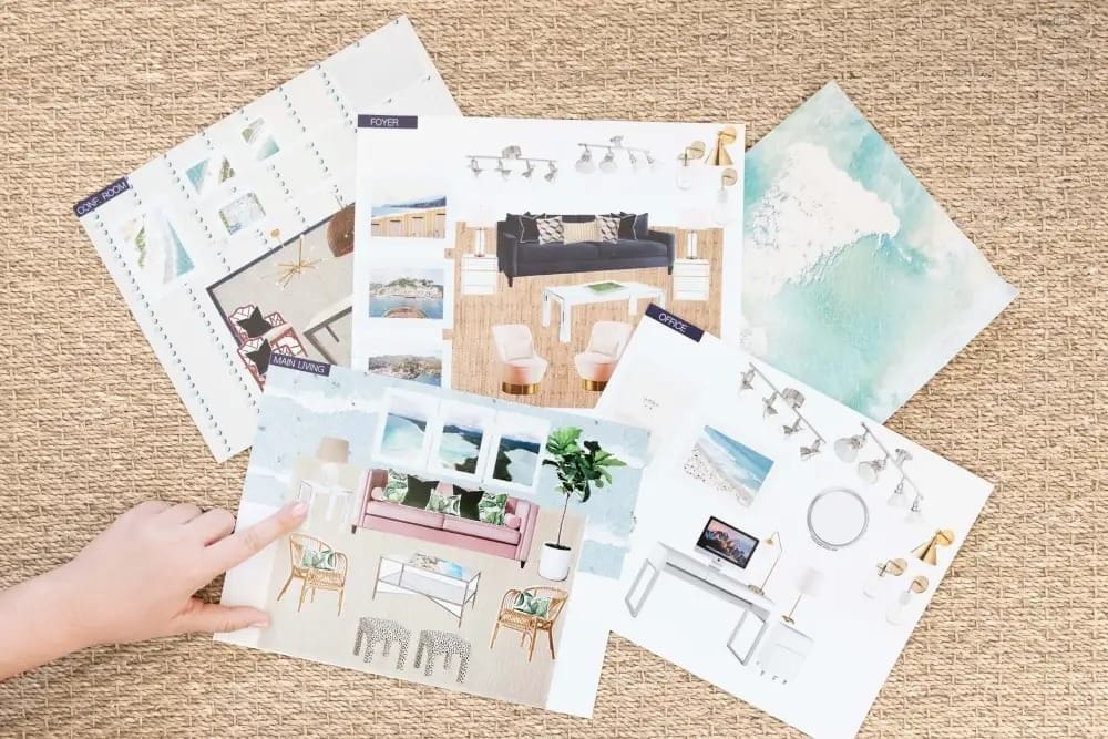 Interior design mood boards and room sketches spread across a carpet